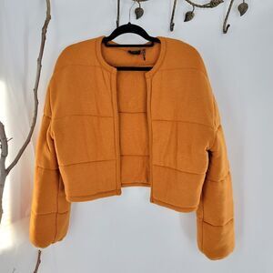 Urban Outfitters out from under burnt orange jacket